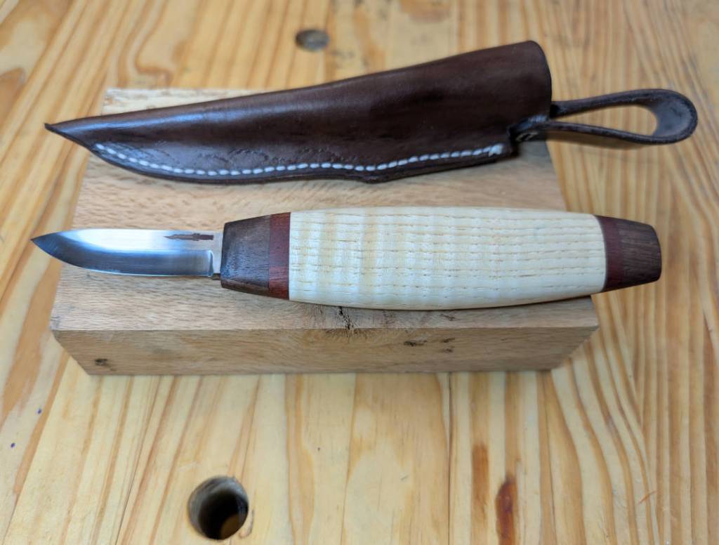 A sloyd woodcarver in curly hickory with bloodwood and walnut accents